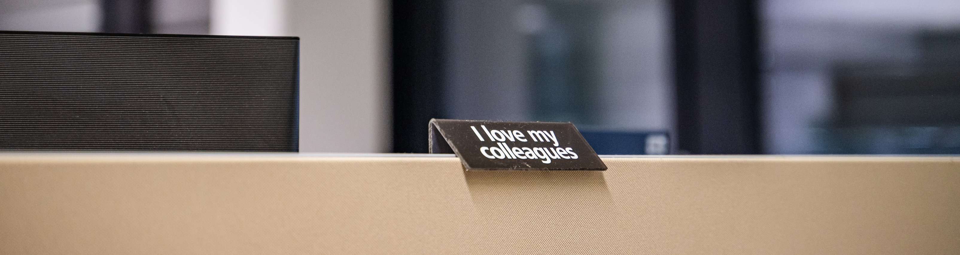 A display pinned to a pinboard with the inscription "I love my colleagues"